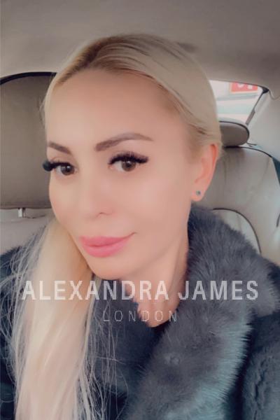 Ariana selfie in a car wearing a grey fur coat