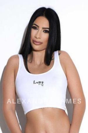 Alisha wearing a white happy crop top